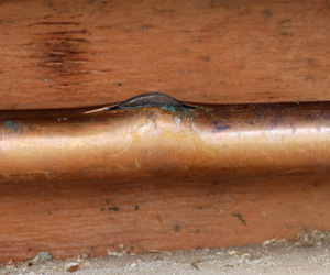 Frozen, ruptured copper pipe.