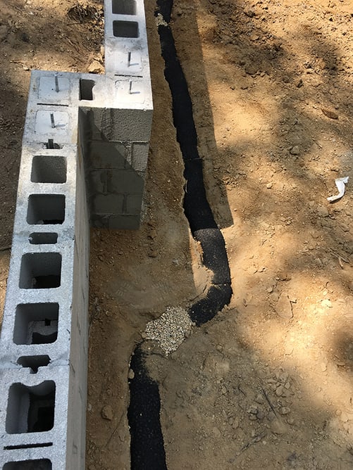Exterior of a crawl space drain system.