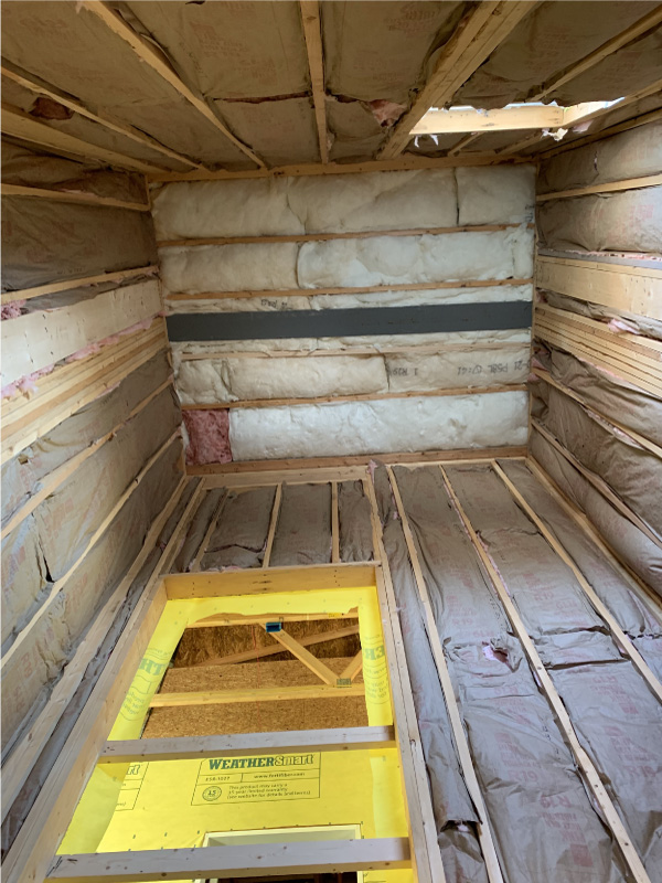 Fiberglass insulation installed in a three-story elevator shaft.