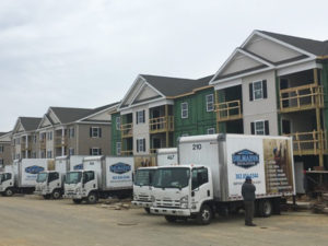 Delmarva Insulation company trucks parked in front of new construction.