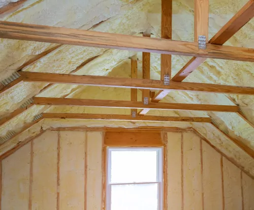 Spray foam insulation in an attic.