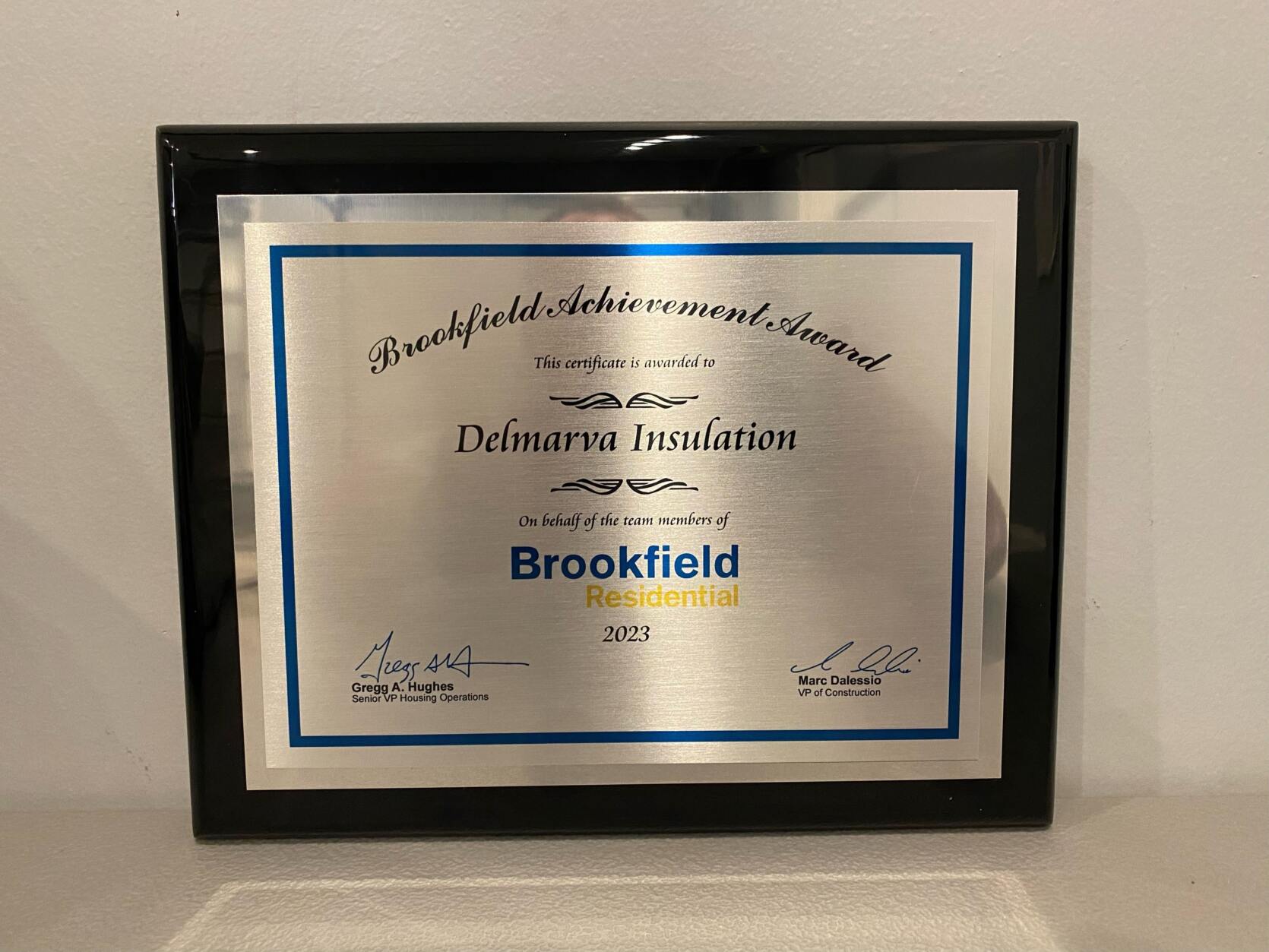 "Brookfield Achievement Award. This certificate is awarded to Delmarva Insulation. On behalf of the team members of Brookfield Residential. 2023. Signed, Gregg A. Hughes, Senior VP Housing Operations and Marc Dalessio, VP of Construction."