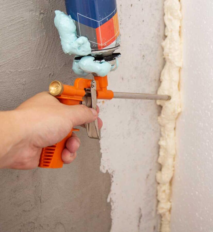 Up-close of man's hand holding air sealing gun.