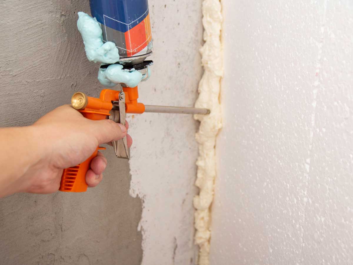 Up-close of man's hand holding air sealing gun.