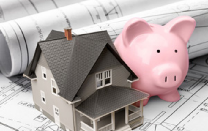 House with architectural plans and piggy bank
