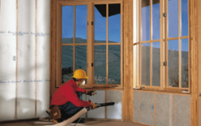 Worker framing a window at a job site