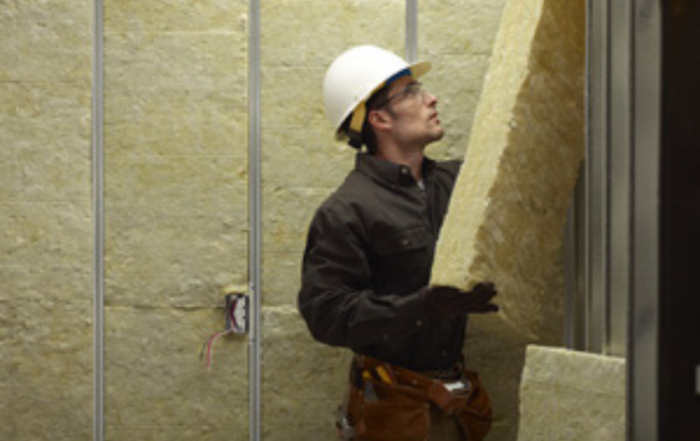 Worker installing rigid board insulation