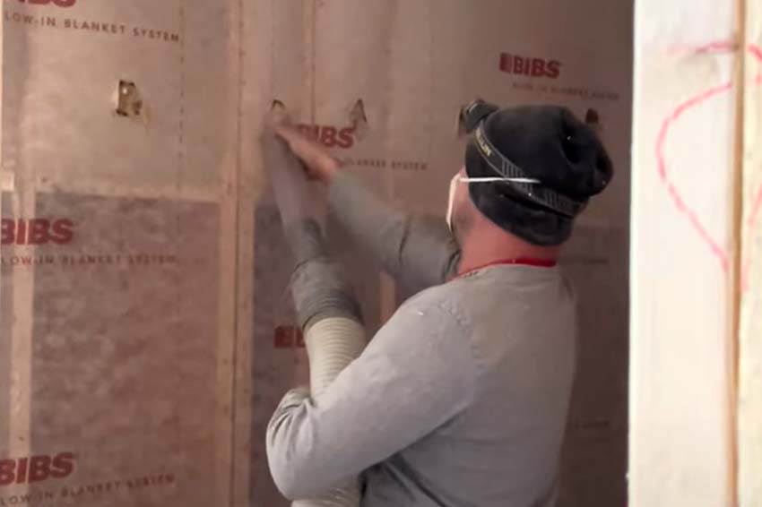 A Delmarva Insulation professional installing BIBS (Blown-In Blanket System) insulation in a residential or commercial space, ensuring energy efficiency and comfort.